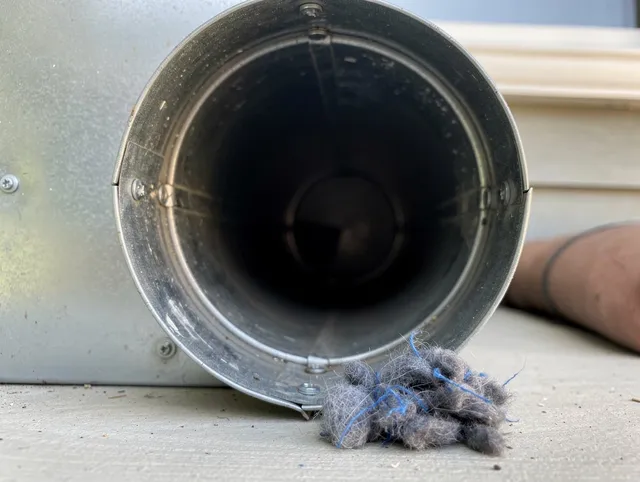 Winchester Dryer Vent Cleaning technician using specialized equipment to clear severe dryer vent blockage in Winchester